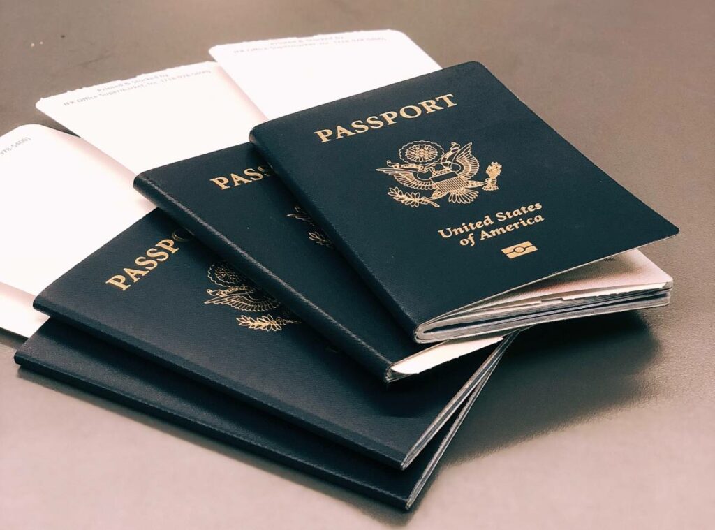 Several United States passports stacked on a table